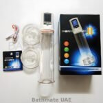 Electronic penis vacuum pump with digital pressure display, transparent chamber, USB cable and accessories.